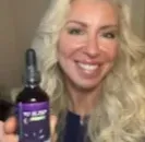 A middle-aged woman appearing revitalized and cheerful in the morning after successfully utilizing the natural sleep restoration protocol.